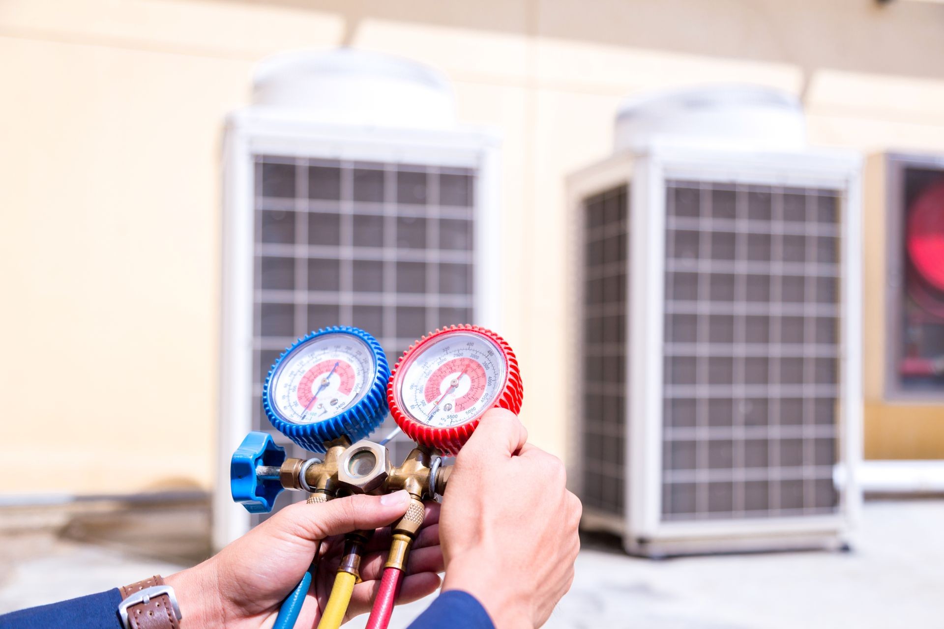 Technician is checking air conditioner ,measuring equipment for filling air conditioners.