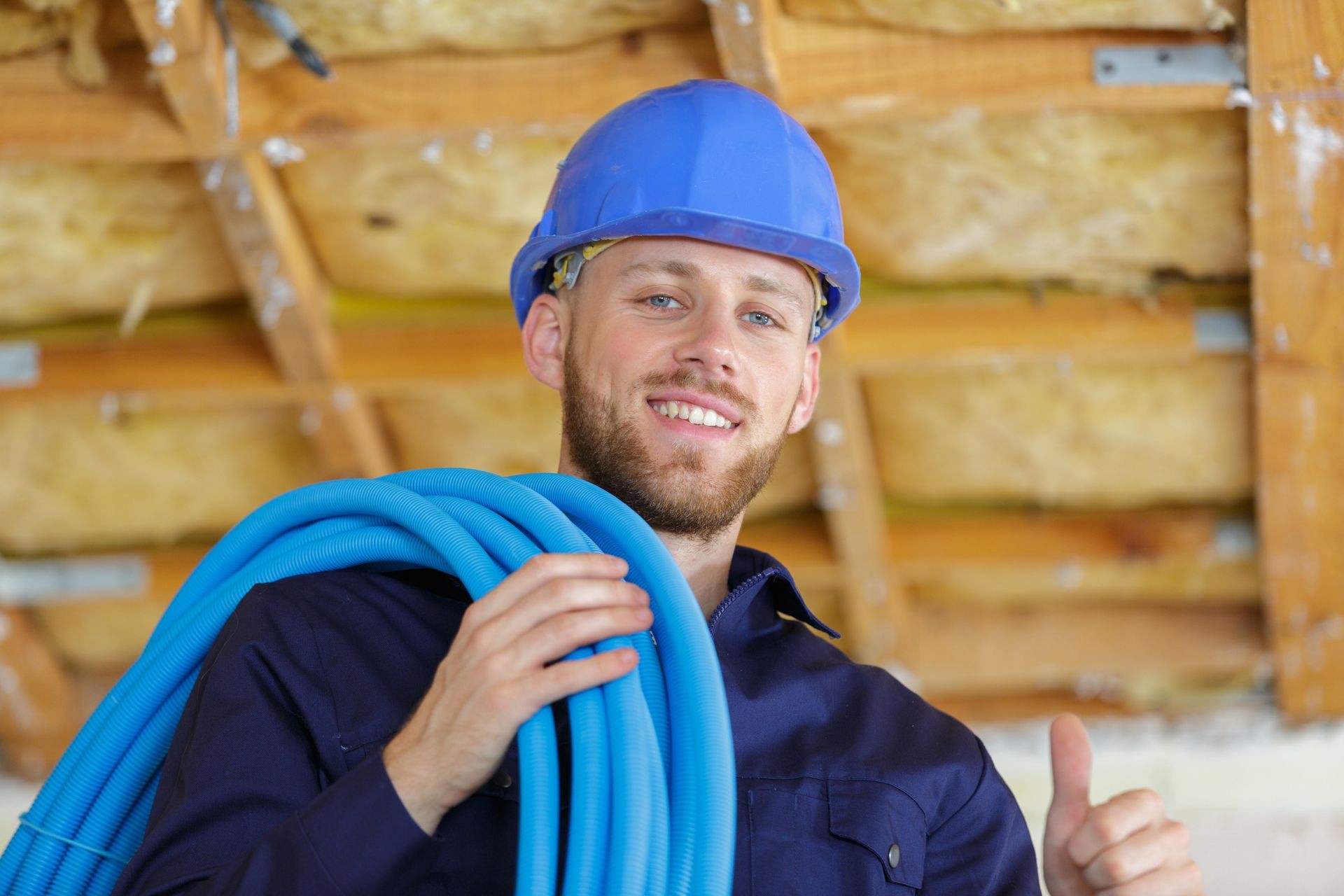 builder holding pipe indoors